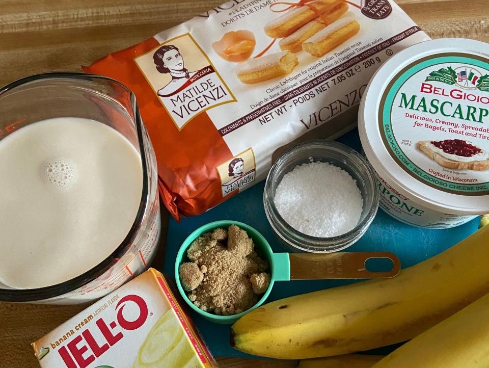 The ingredients for the caramelized banana pudding cake laid out on wood counter