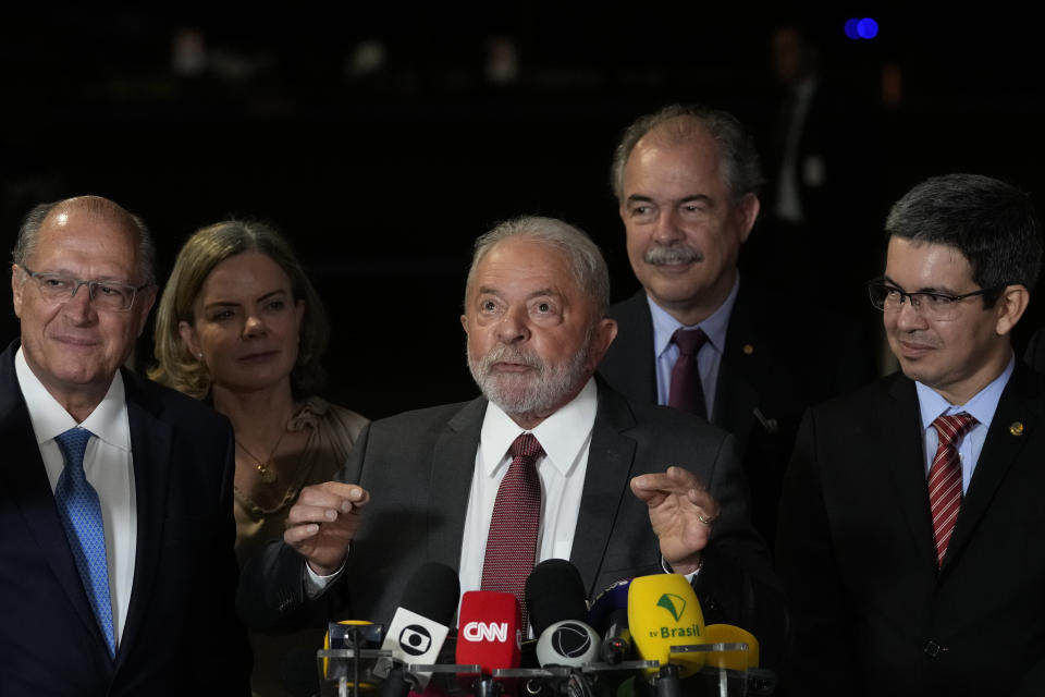 Brazilian President-elect Luiz Inacio Lula da Silva, center, accompanied by Vice President-elect Geraldo Alckmin, left, speaks during a press conference after meeting with the president of the Supreme Electoral Court, in Brasilia, Brazil, Wednesday, Nov. 9, 2022. On his first day in Brazil's capital after winning the runoff election, Da Silva is meeting with the leaders of each house of Congress ahead of his inauguration on Jan. 1. (AP Photo/Eraldo Peres)