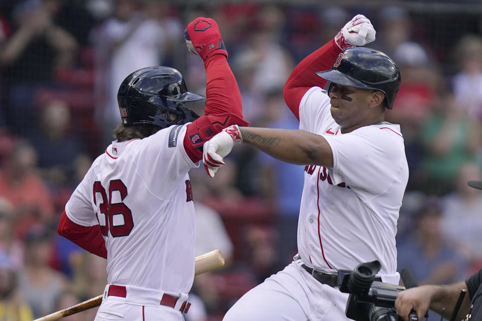 Boston Red Sox's Rafael Devers, right, celebrates with Triston Casas, left, after arriving home to score on a home run in the fourth inning of the first game of a baseball doubleheader against the New York Yankees, Tuesday, Sept. 12, 2023, in Boston. (AP Photo/Steven Senne)