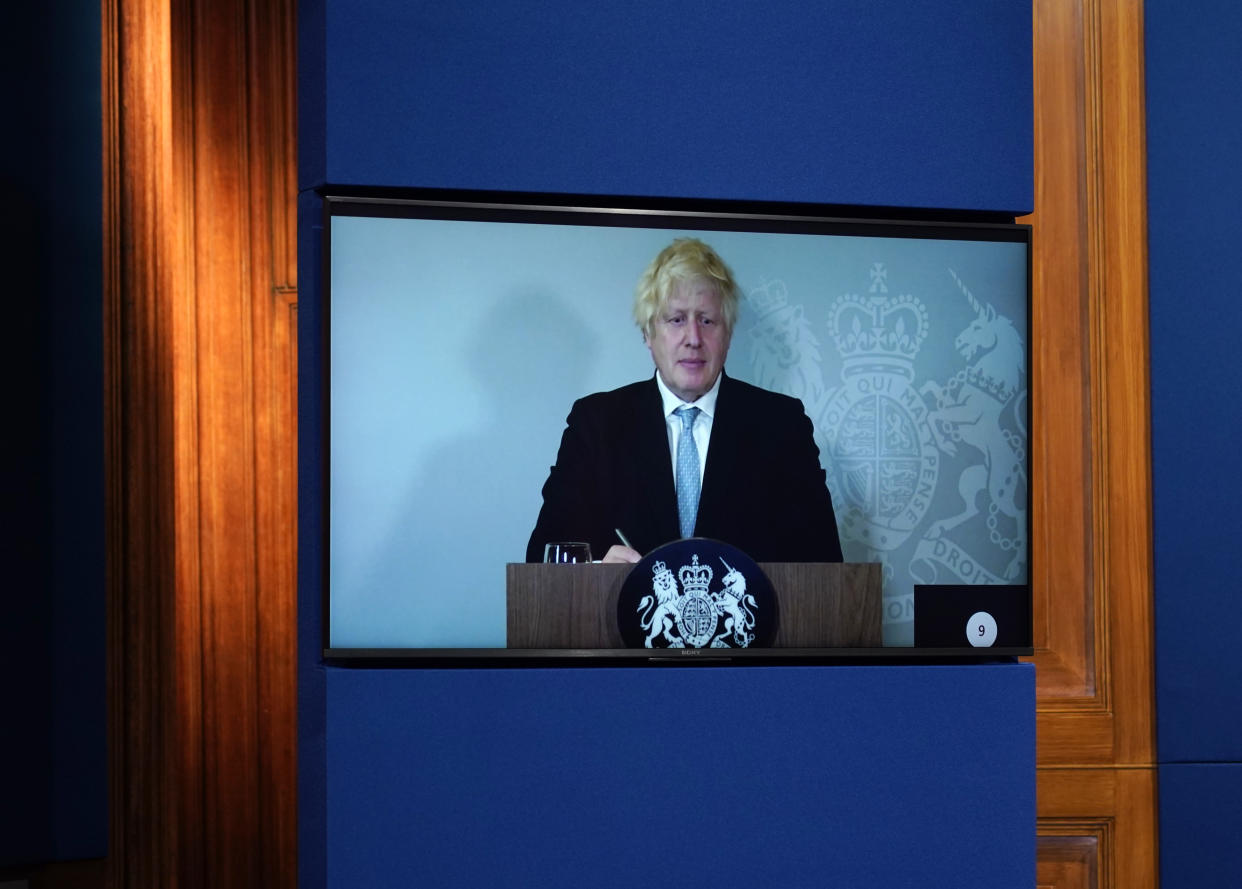 LONDON, ENGLAND - JULY 19: Britain's Prime Minister, Boris Johnson attends a media briefing on coronavirus online via a screen from Chequers, the country house of the Prime Minister where he is self-isolating at Downing Street on July 19, 2021 in London, England. The Prime Minister and Chancellor were both contacted by Track and Trace this weekend after the Health Minister, Sajod Javid, tested positive for the Covid-19 virus. Today sees the complete relaxation of Covid lockdown rules and is being dubbed 