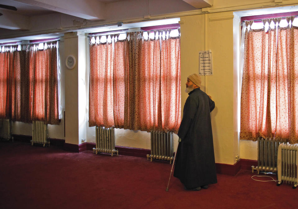 FILE - In this Feb. 15, 2012, file photo, Ismael el-Shikh stands in a prayer room at the Islamic Culture Center in Newark, N.J. Americans in New Jersey’s largest city were subjected to surveillance as part of the New York Police Department’s effort to build databases of where Muslims work, shop and pray. The special unit that conducted the program has been disbanded, the NYPD confirmed on Tuesday, April 15, 2014. The surveillance program by the NYPD Intelligence Division had come under fire by community activists who accused the department of abusing civil rights. (AP Photo/Charles Dharapak, File)