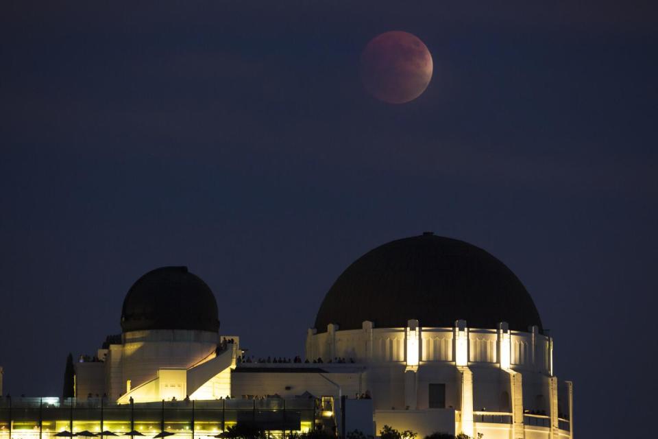 A super blood moon rises over the Griffith Park Observatory in L.A.