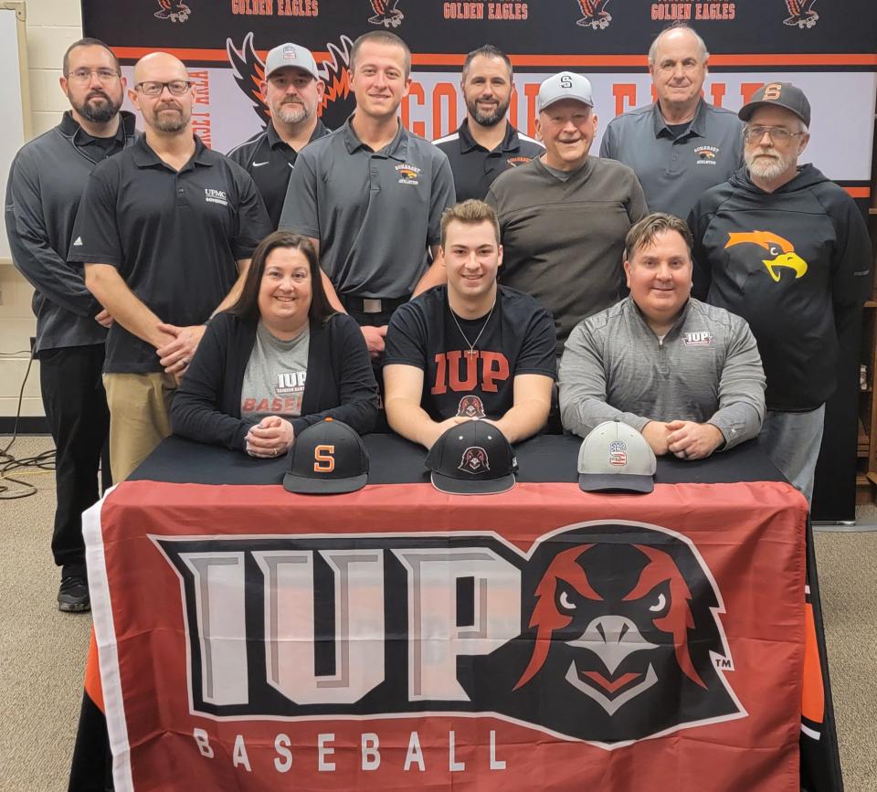 Flanked by parents Kelly and Craig Krotzer, Somerset senior student-athlete Hunter Krotzer announces him commitment to attend and play baseball at Indiana University of Pennsylvania, Tuesday, in Somerset. Pictured in middle row, from left, Somerset Strength and Conditioning coach Dave Polcha, assistant baseball coach Austin Sleek, Somerset American Legion Baseball Club assistant coach Randy Close and Somerset assistant coach Dave Walker, back, Somerset athletic trainer Justin Delaini, assistant coach Bart Close, head coach Jimmy Mayer and assistant coach Bob Mayer.