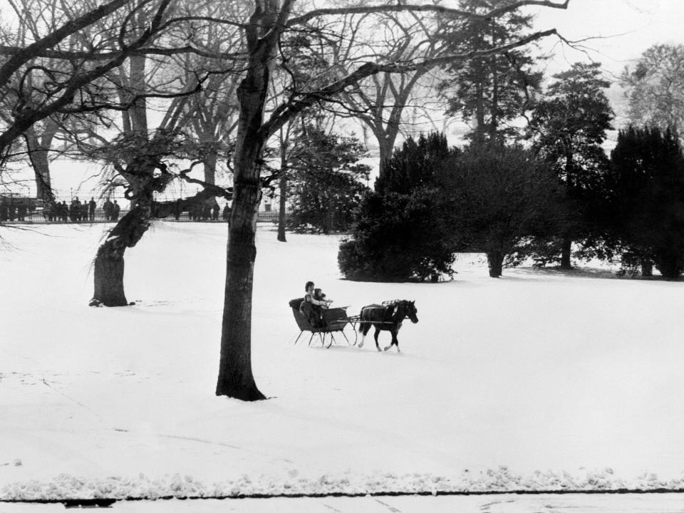 Jackie Kennedy and her children enjoyed a sleigh ride on snow covered grounds in 1962.