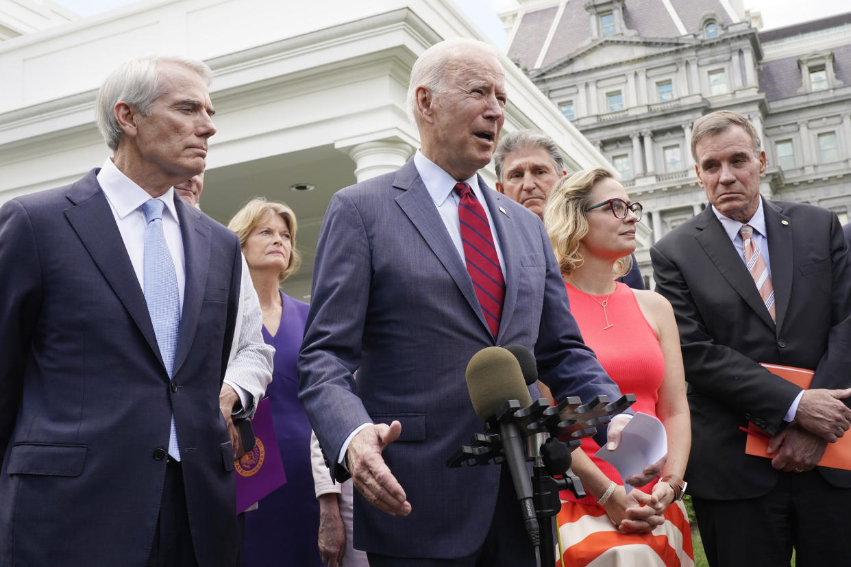 President Biden, with a bipartisan group of senators, speaks June 24, 2021, outside the White House in Washington, after discussing the infrastructure plan. From left are, Sen. Rob Portman, R-Ohio, Sen. Lisa Murkowski, R-Alaska, Biden, Sen. Joe Manchin, D-W.Va., Sen. Kyrsten Sinema, D-Ariz. and Sen. Mark Warner, D-Va. (AP Photo/Jacquelyn Martin)