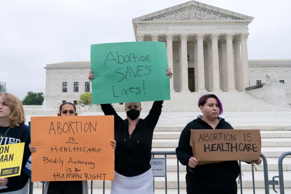 Demonstrators protest outside the U.S. Supreme Court on May 3, 2022. i