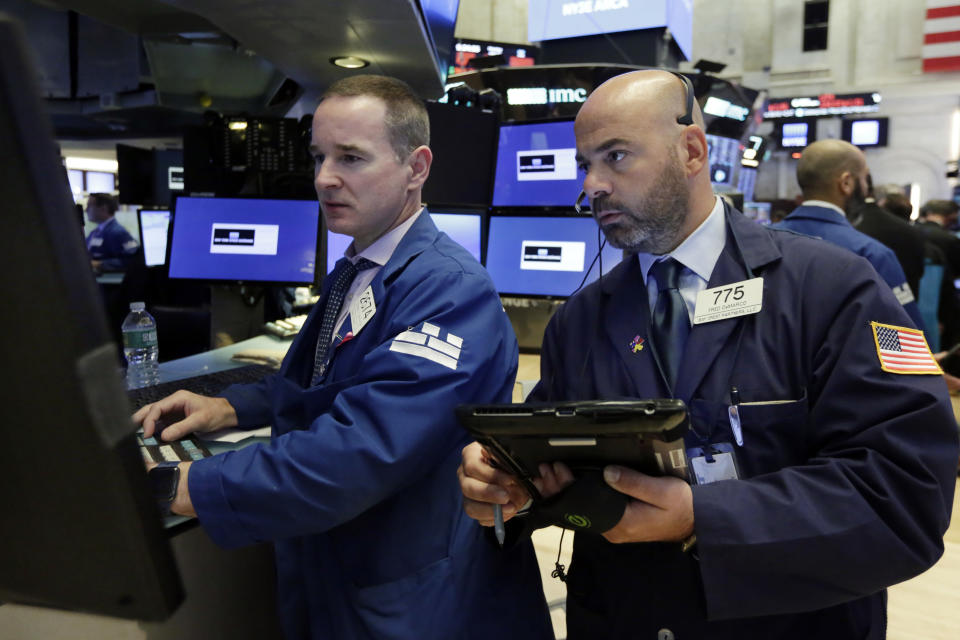 Specialist Stephen Naughton, left, and trader Fred DeMarco work on the floor of the New York Stock Exchange, Monday, July 30, 2018. Stocks are off to a mixed start on Wall Street as gains in banks and energy companies are offset by losses in other sectors. (AP Photo/Richard Drew)