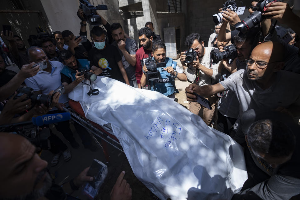 FILE - Members of the World Central Kitchen aid group, transports the body of one of the six foreign aid workers who were killed in an Israeli strike, at a hospital morgue in Rafah, Wednesday, April 3, 2024. World Central Kitchen and a few other aid groups suspended operations in Gaza, after seven aid workers were killed by airstrikes. Yet despite the danger, many of the largest organizations barely slowed down. Hunger has become commonplace in Gaza amid the war with Israel, and U.N. officials warn that famine is increasingly likely in northern Gaza. (AP Photo/Fatima Shbair, File)