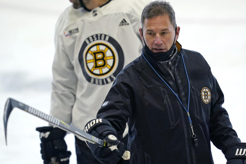 Boston Bruins head coach Bruce Cassidy instructs his players at the team's NHL hockey training camp, Monday, Jan. 4, 2021, in Boston. (AP Photo/Elise Amendola)