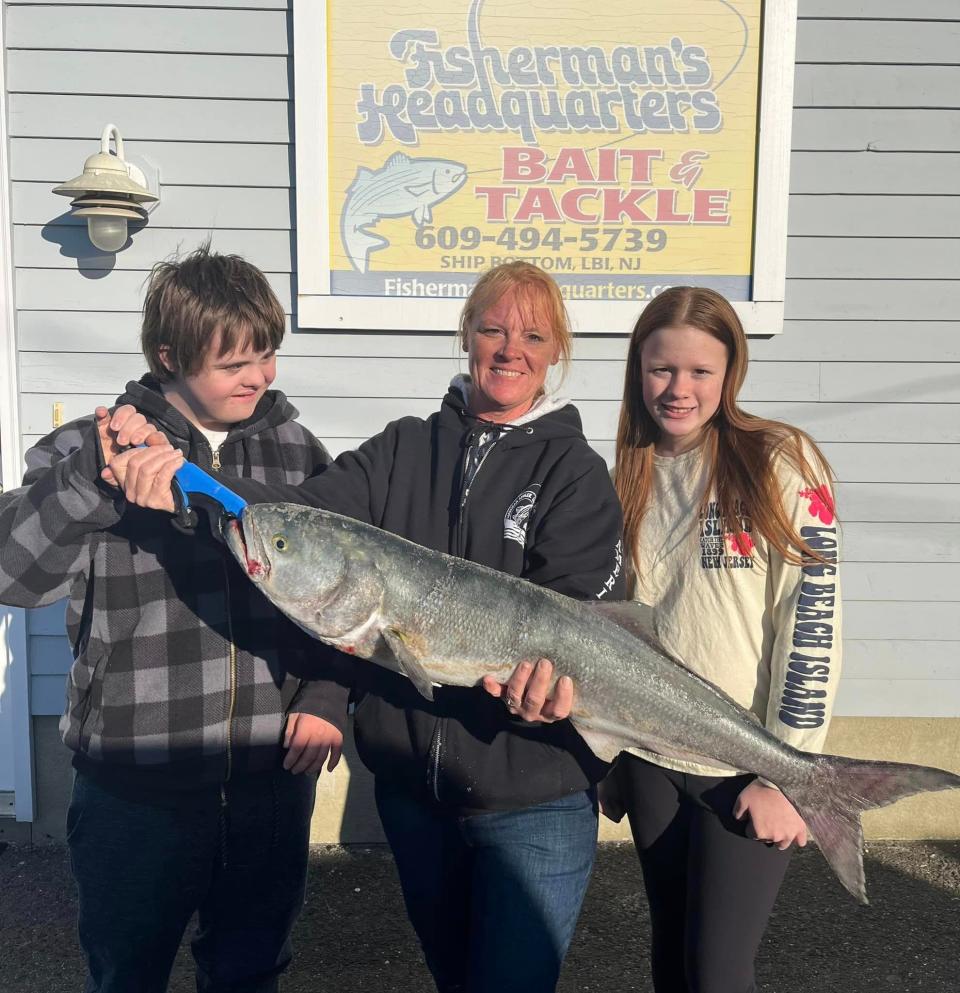 Brandy Hillegass, center, holds the bluefish she caught in the Long Beach Island surf. She weighed it in at Fisherman's Headquarters in Ship Bottom. On her right is her son Aidan and to her right is her daughter Savannah.