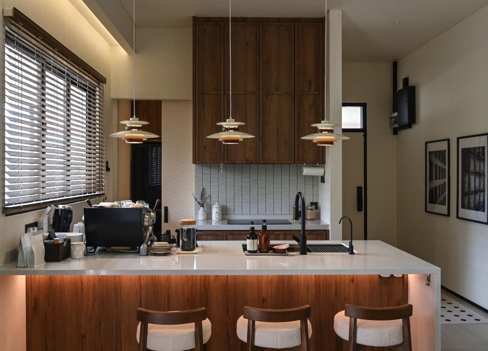 The kitchen counter features dark wood accents.