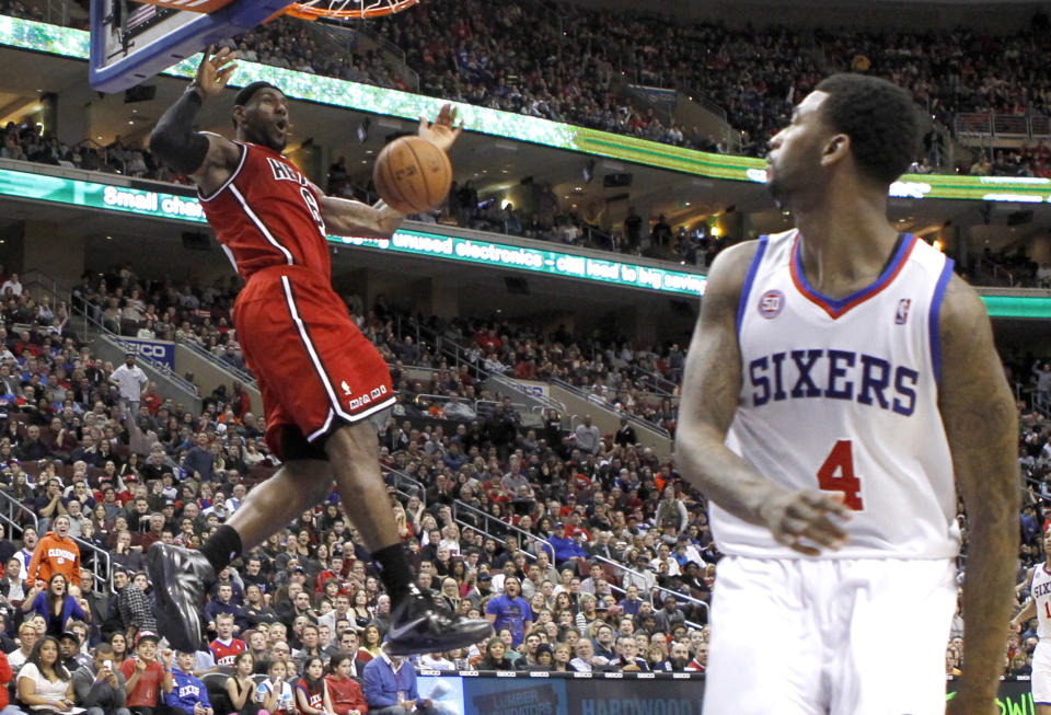 Miami Heat forward LeBron James dunks the ball near the Philadelphia 76ers forward Dorell Wright (4) during their NBA basketball game in Philadelphia, Pennsylvania, February 23, 2013. REUTERS/Tim Shaffer(UNITED STATES - Tags: SPORT BASKETBALL TPX IMAGES OF THE DAY) - RTR3E70B