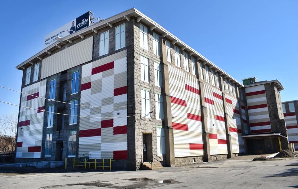 The mill at 288 Plymouth Ave., once home of the Richard Borden Manufacturing Co., is covered in multicolored corrugated metal panels.