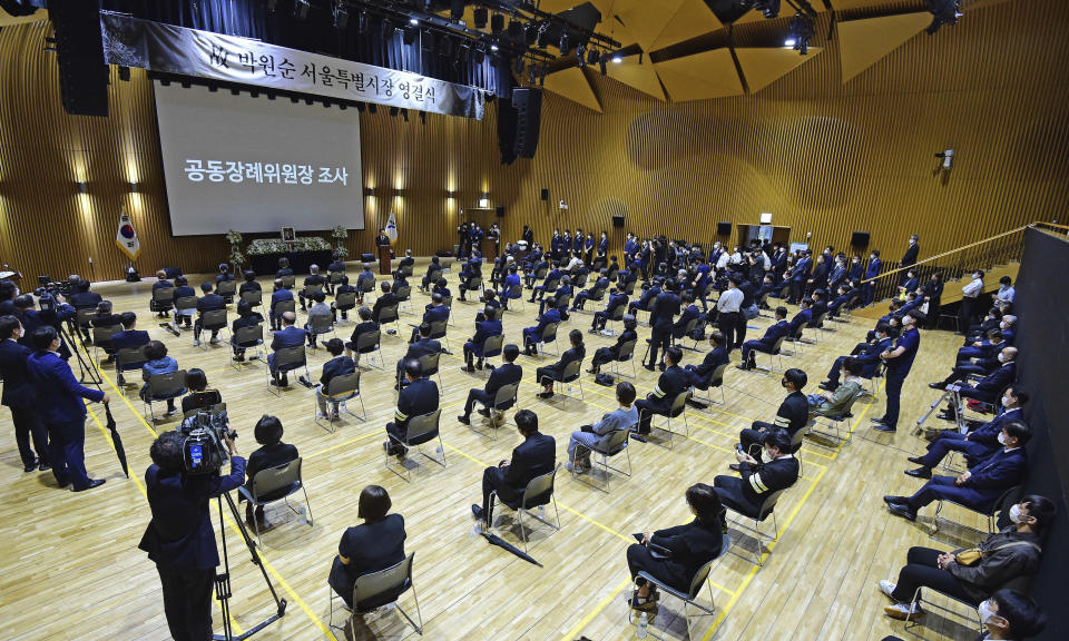 About 100 people attend an official funeral of late Seoul Mayor Park Won-soon while maintaining social distancing at the Seoul City Hall in Seoul, South Korea, Monday, July 13, 2020. Park was found dead in wooded hill in northern Seoul on Friday after massive police searches for him. (Korea Pool/Yonhap via AP)