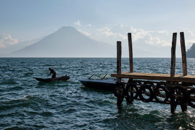 nancy-ng-lake-atitlan.jpg Fisherman in a small boat fishing in Lake Atitlan with views - Credit: Photo by Jorge Fernández/LightRocket via Getty Images