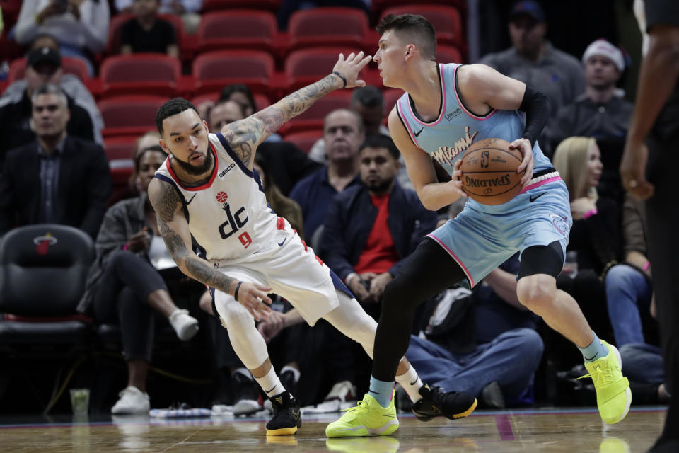Miami Heat guard Tyler Herro, right, prepares to shoot as Washington Wizards guard Chris Chiozza (9) defends during the first half of an NBA basketball game, Friday, Dec. 6, 2019, in Miami. (AP Photo/Lynne Sladky)