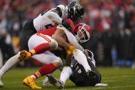 Jacksonville Jaguars linebacker Foyesade Oluokun (23)and linebacker Devin Lloyd (33) hit Kansas City Chiefs tight end Travis Kelce (87) during the first half of an NFL divisional round playoff football game, Saturday, Jan. 21, 2023, in Kansas City, Mo. (AP Photo/Jeff Roberson)