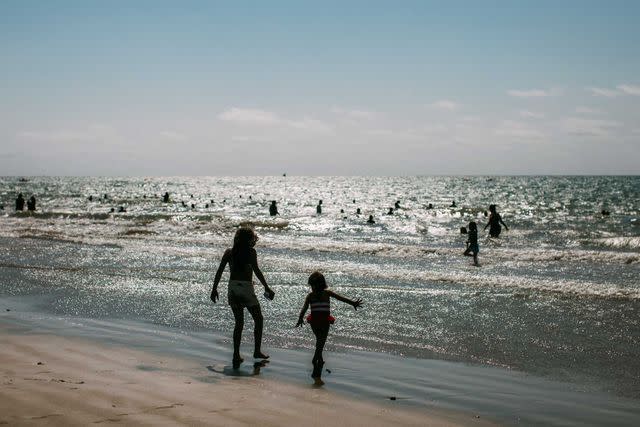 <p>Rose Marie Cromwell</p> Playing in the waves at Murciélago Beach, in Manta.