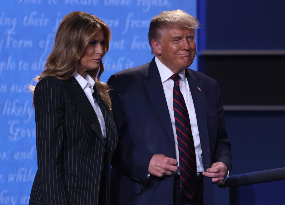 CLEVELAND, OHIO - SEPTEMBER 29:  U.S. President Donald Trump and first lady Melania Trump smile on stage after the first presidential debate between Trump and Democratic presidential nominee Joe Biden at the Health Education Campus of Case Western Reserve University on September 29, 2020 in Cleveland, Ohio. This is the first of three planned debates between the two candidates in the lead up to the election on November 3. (Photo by Scott Olson/Getty Images)