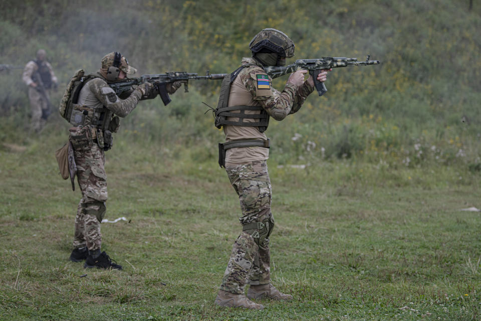 Volunteer soldiers attend a training outside Kyiv, Ukraine, Saturday, Aug. 27, 2022. Some volunteers signed up to join a Chechen unit that fights alongside the Ukrainian military. Fighters from Chechnya, the Russian republic in the North Caucasus, are participating on both sides of the conflict in Ukraine, with pro-Kyiv volunteers loyal to Dzhokhar Dudayev, the late Chechen leader who headed the republic's drive for independence from Russia. (AP Photo/Andrew Kravchenko)