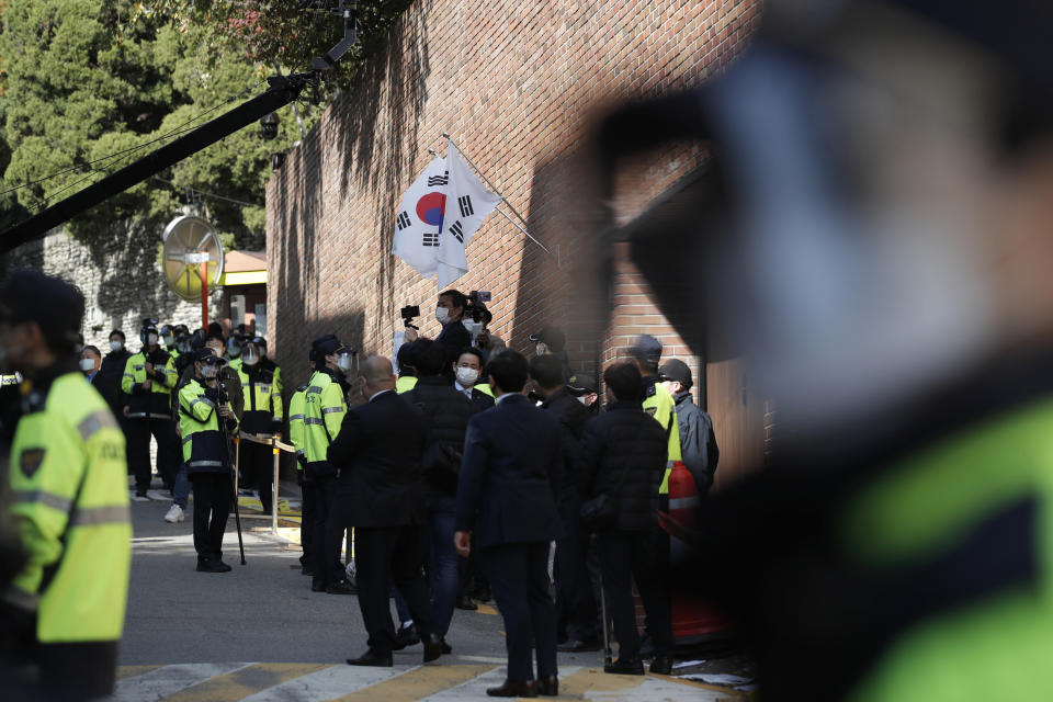 South Korean police officers stand outside a residence of former President Lee Myung-bak in Seoul, South Korea, Monday, Nov. 2, 2020. Lee was sent back to prison on Monday, four days after the country’s top court upheld a 17-year prison term on him over corruption crimes. (AP Photo/Lee Jin-man)