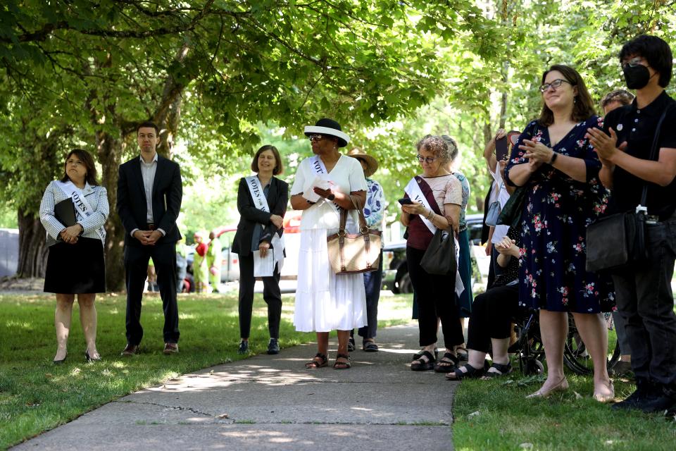 Speakers and guests look on during an unveiling ceremony for the women’s suffrage marker at Oregon State Capitol State Park.