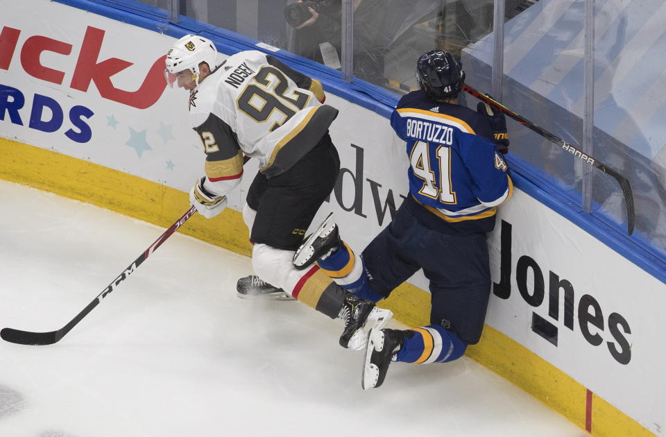 St. Louis Blues' Robert Bortuzzo (41) is checked by Vegas Golden Knights Tomas Nosek (92) during second-period NHL hockey playoff game action in Edmonton, Alberta, Thursday, Aug. 6, 2020. (Jason Franson/The Canadian Press via AP)