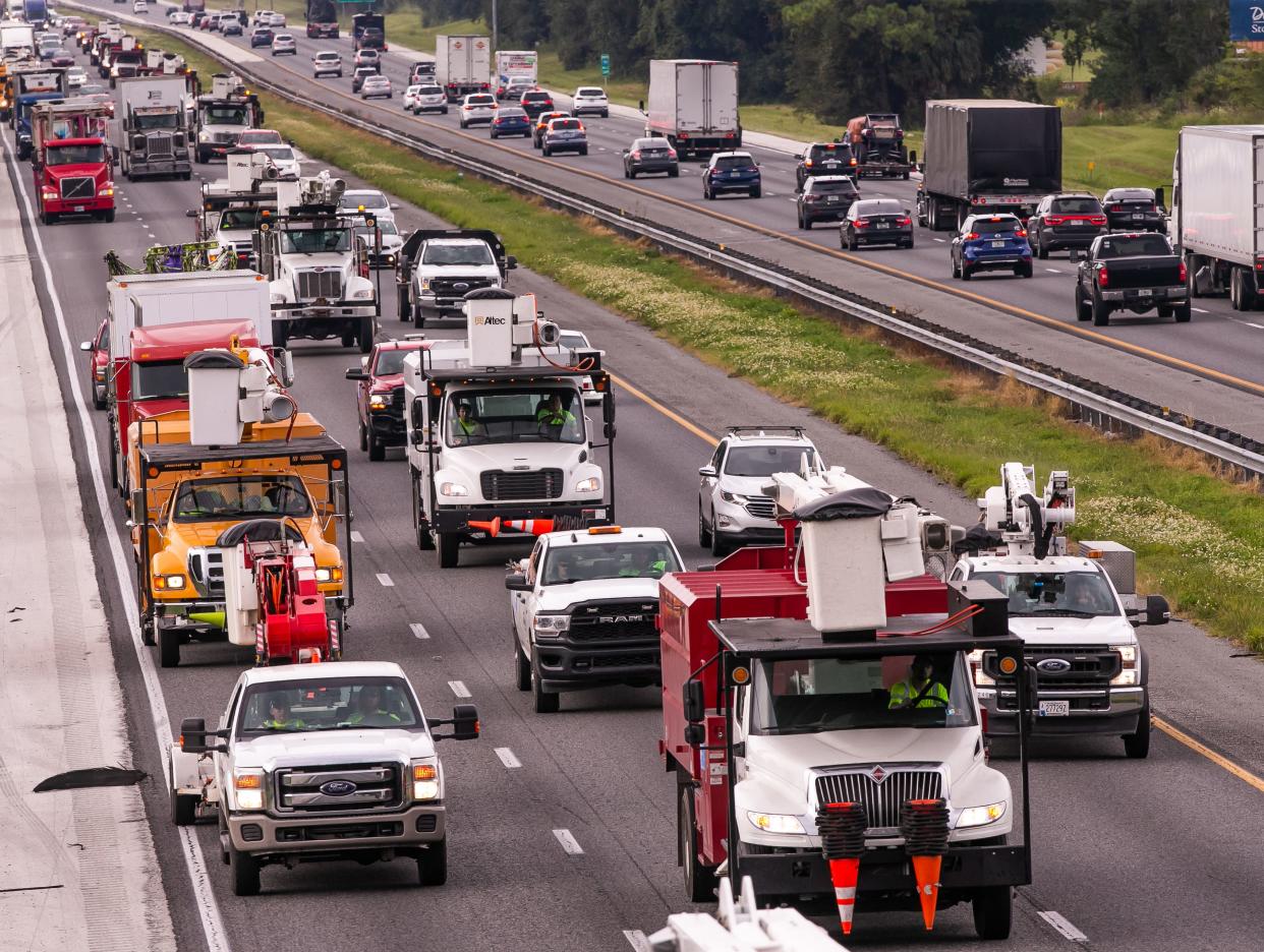 Utility and tree service vehicles were heading south on I75 near Ocala, FL, as people were preparing for Hurricane Ian on Tuesday, September 27, 2022. Ian is expected to make landfall Venice late Wednesday to early Thursday morning. [Doug Engle/Ocala Star Banner]