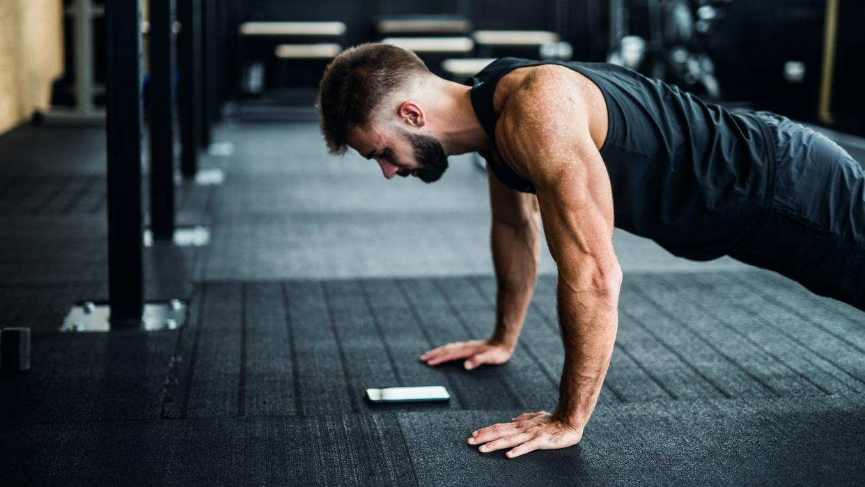 Man using phone in a gym.