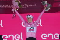 Slovenia's Tadej Pogacar wears the pink jersey of the race overall leader as he celebrates on podium after completing the 9th stage of the of the Giro d'Italia cycling race, from Avezzano to Naples, Italy, Sunday, May 12, 2024. (Gian Mattia D'Alberto/LaPresse via AP)