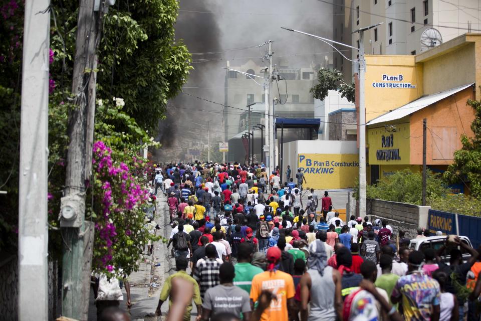 <p>People walk in the street during protests over the fuel price increase in Port-au-Prince, Haiti, on Saturday, July 7, 2018. (Photo: Dieu Nalio Chery/AP) </p>