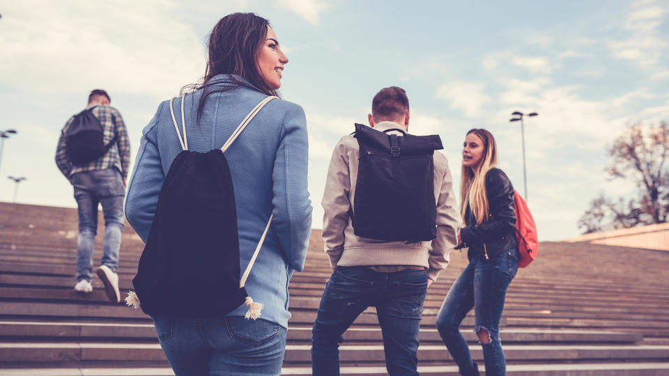 Group of Students with Backpacks Walking to School.