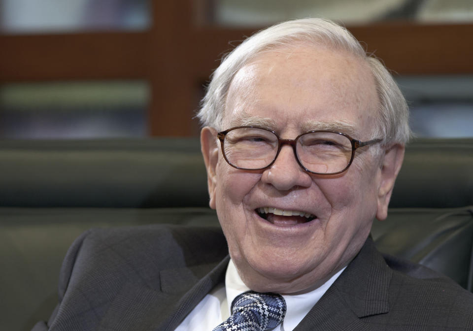 Berkshire Hathaway CEO Warren Buffett grins during an interview.