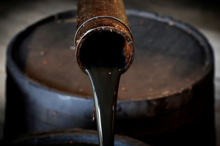 Oil pours out of a spout from Edwin Drake's original 1859 well that launched the modern petroleum industry at the Drake Well Museum and Park in Titusville, Pennsylvania U.S., October 5, 2017. REUTERS/Brendan McDermid/File Photo