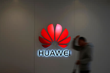 A man walks by a Huawei logo at a shopping mall in Shanghai, China December 6, 2018. REUTERS/Aly Song/Files