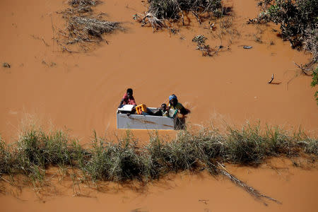 FILE PHOTO: A child is transported on a fridge during floods after Cyclone Idai, in Buzi, outside Beira, Mozambique, March 21, 2019. REUTERS/Siphiwe Sibeko