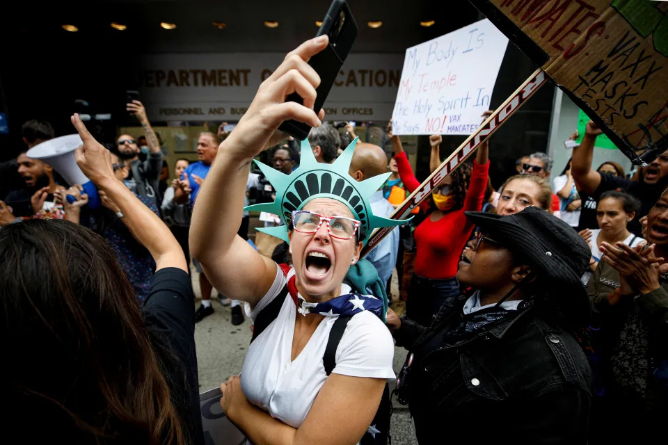 A protester, who identified herself as a school teacher, demonstrates against the mandate that teachers and staff in the NYC Schools system be vaccinated against COVID, in New York City, October 4, 2021. REUTERS/Brendan McDermid