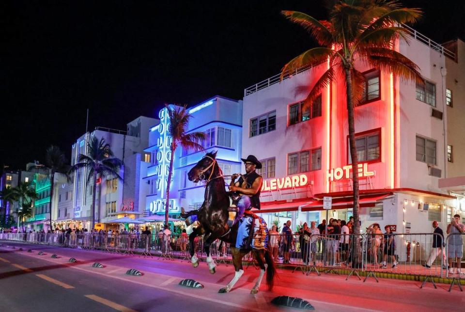 Spring breaker Stephen Harmon rides Little Bit on Ocean Drive while visiting South Beach from South Carolina on Miami Beach, Florida on Friday, March 8, 2024