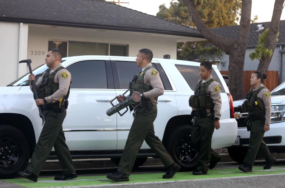 L.A. County sheriff's deputies approach Supervisor Sheila Kuehl's house the morning of the raids.