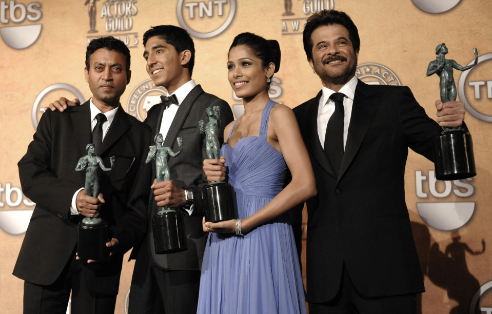 FILE - In this Jan. 25, 2009 file photo, members of the cast of "Slumdog Millionaire," from left, Irrfan Khan, Dev Patel, Freida Pinto and Anil Kapoor, pose backstage with the award for outstanding performance by a cast in a motion picture during the 15th Annual Screen Actors Guild Awards in Los Angeles. Khan has appeared in films such as “Slumdog Millionaire” and “Jurassic World,” but now the actor is facing the biggest challenge of his life as he undergoes treatment for cancer in London. (AP Photo/Chris Pizzello, File)