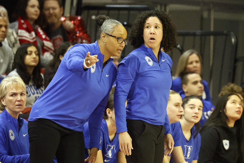 Duke head coach Kara Lawson listens to associate head coach Tia Jackson during the first half of an NCAA college basketball game against North Carolina State, Sunday, Jan. 21, 2024, in Raleigh, N.C. (AP Photo/Karl B. DeBlaker)