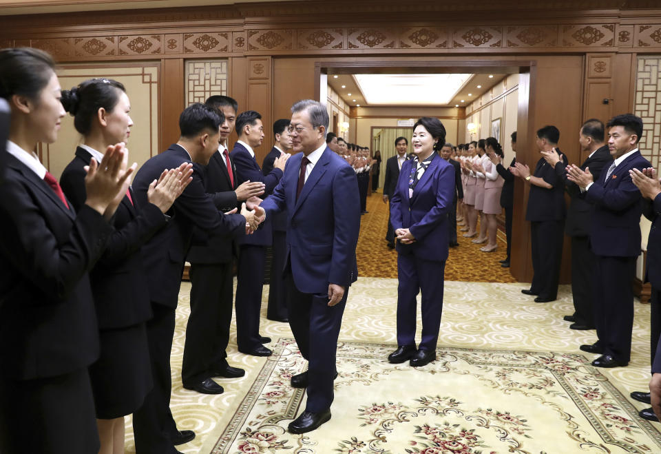 South Korean President Moon Jae-in shakes hands with a staff member of Paekhwawon State Guesthouse as his wife Kim Jung-sook looks on before leaving for the Mount Paektu, in Pyongyang, North Korea, Thursday, Sept. 20, 2018. (Pyongyang Press Corps Pool via AP)