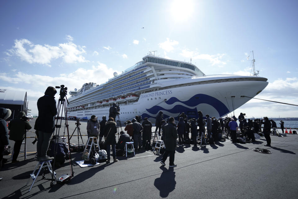 The cruise ship Diamond Princess is anchored at Yokohama Port for supplies replenished in Yokohama, south of Tokyo, Thursday, Feb. 6, 2020. Health workers said 10 more people from the Diamond Princess were confirmed ill with the virus, in addition to 10 others who tested positive on Wednesday. They were dropped off as the ship docked and transferred to nearby hospitals for further test and treatment. (AP Photo/Eugene Hoshiko)