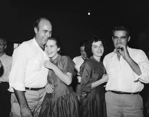 PHOTO: After their acquittal in the Emmett Till trial, defendant Roy Bryant (R), smokes a cigar as his wife happily embraces him and his half brother, J.W. Milam and his wife show jubilation.  (Bettmann Archive via Getty Images)