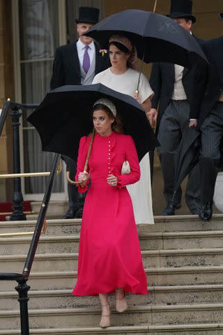 <p>Yui Mok-WPA Pool/Getty </p> Princess Beatrice (front) and Princess Eugenie (behind) at the Buckingham Palace garden party on May 21, 2024