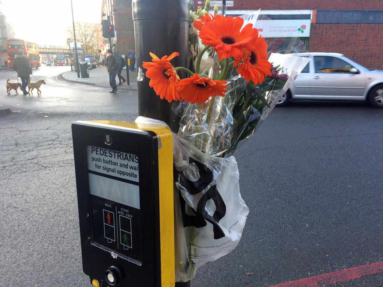 Flowers left at the scene for the woman in Tulse Hill, south London: PA