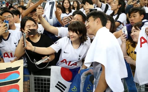 Heung-Min Son of Tottenham Hotspur signs autographs and takes photos with fans after the International Champions Cup match between Juventus and Tottenham Hotspur at the Singapore National Stadium  - Credit: Getty Images