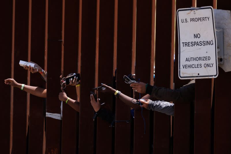 Migrants gather along the U.S. Mexico border near San Diego before the lifting of Tile 42