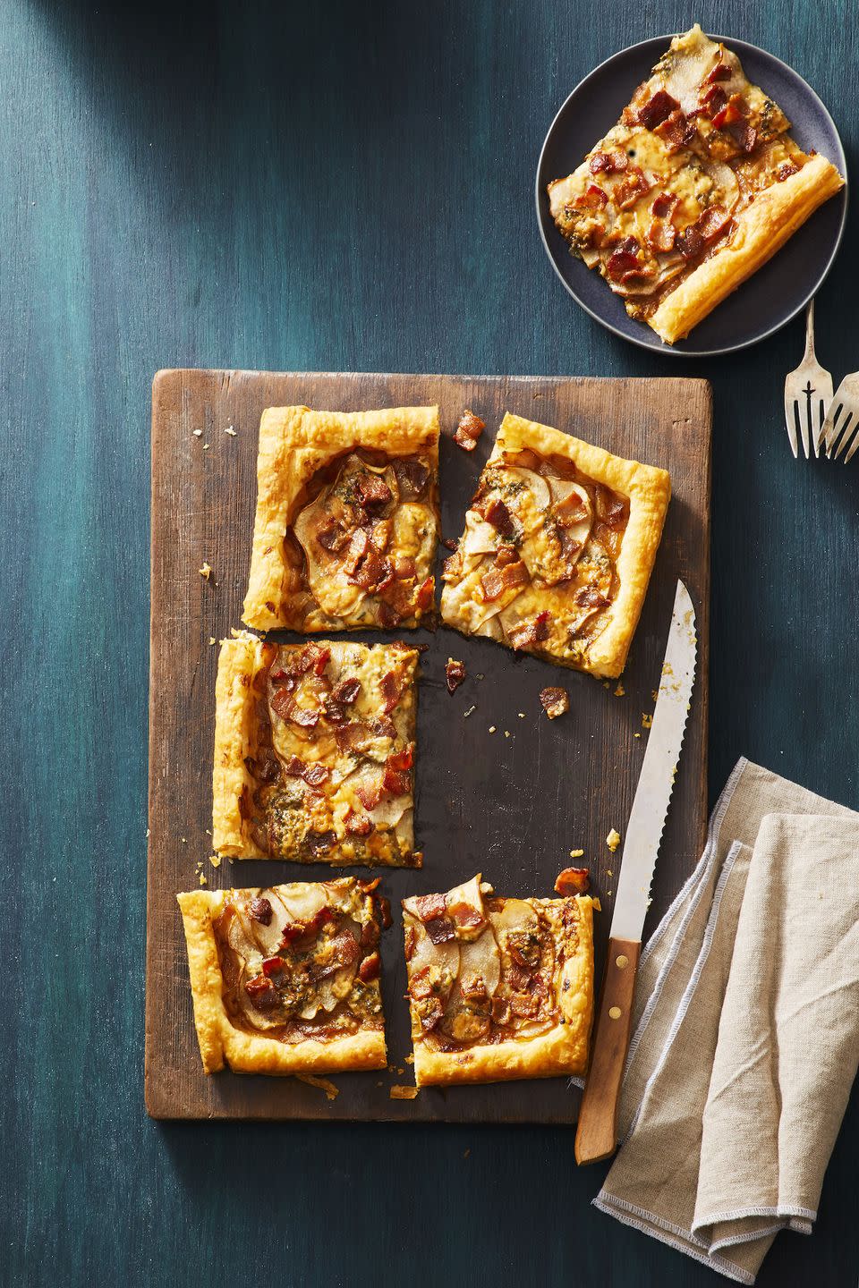 <p>Salty, sweet and fit for fall, this five-ingredient appetizer is as delicious as it is easy.</p><p>Get the <strong><a href="https://www.goodhousekeeping.com/food-recipes/a30434015/pear-blue-cheese-tart-recipe/" rel="nofollow noopener" target="_blank" data-ylk="slk:Pear, Bacon, and Blue Cheese Tart recipe;elm:context_link;itc:0;sec:content-canvas" class="link ">Pear, Bacon, and Blue Cheese Tart recipe</a></strong>.</p>