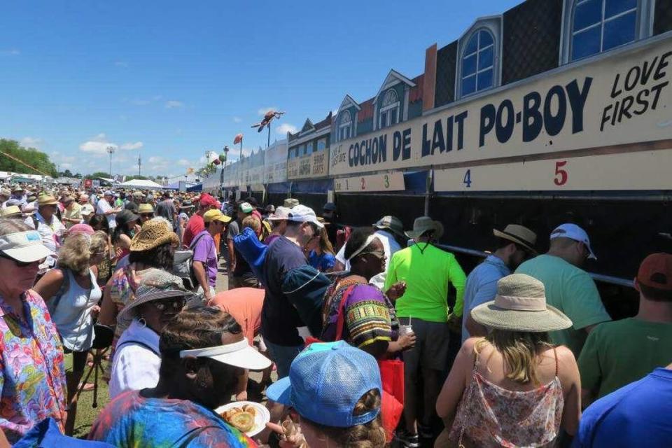 Crowds line up to get food at a prior Jazz Fest in New Orleans.